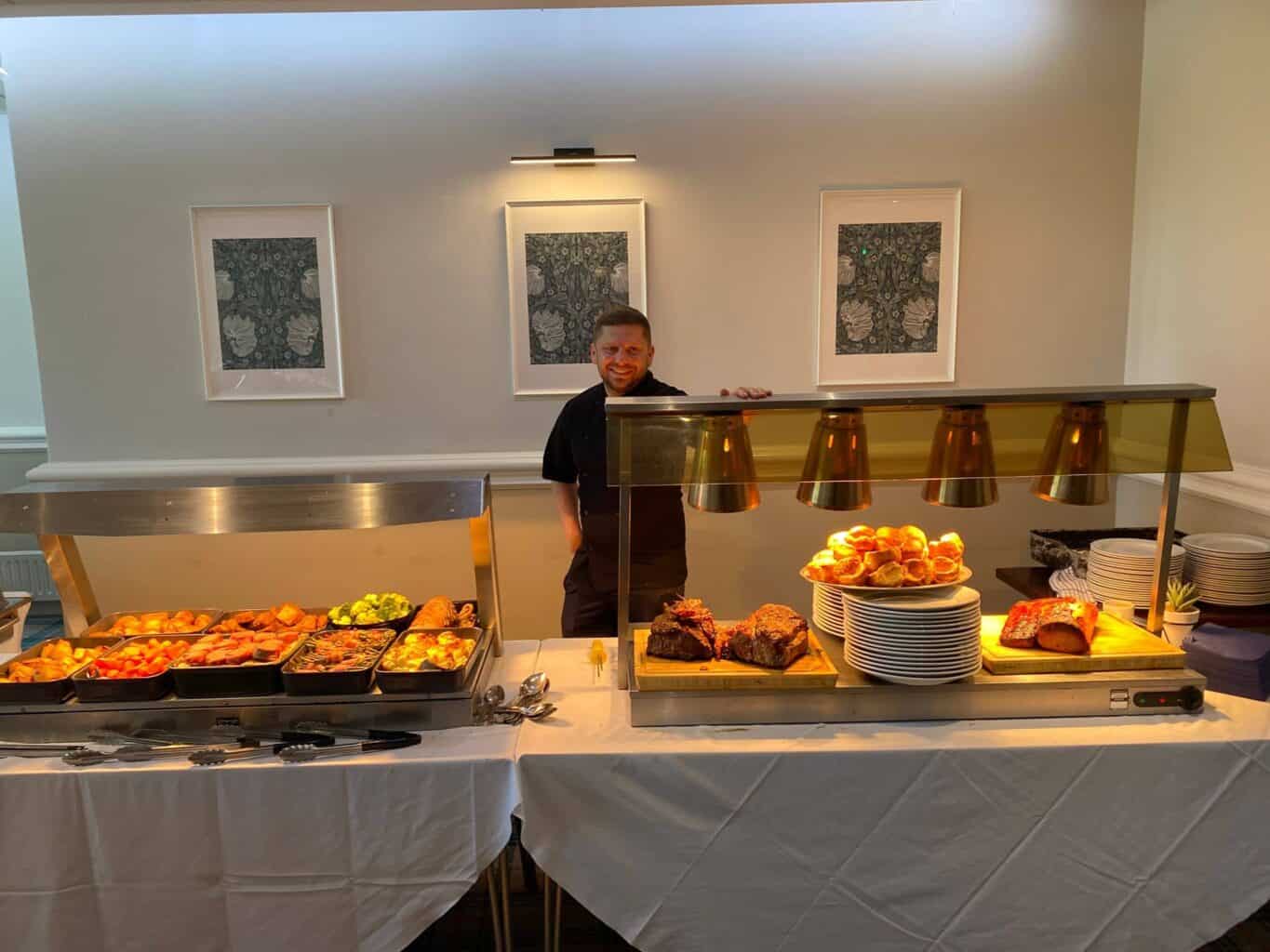 Our chef behind the Sunday carvery counter at Horsforth Golf Club, with roast joints, Yorkshire puddings and hot vegetables ready to serve under warming lamps.